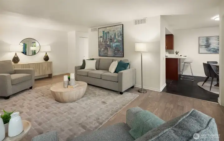 Living room flowing seamlessly into kitchen and dining area.