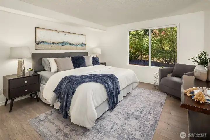 Primary bedroom with large windows.