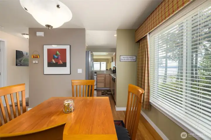 From the dining area looking into the kitchen, with those stunning water views visible through the window - one bonus of a corner unit is light from two directions...and views from every room.