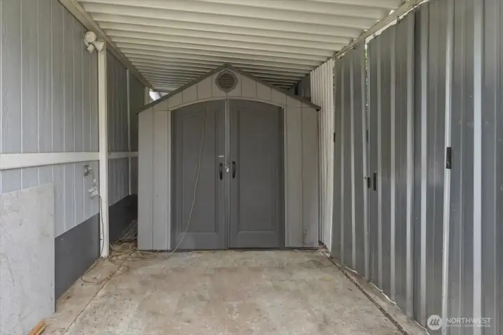 Shed in covered area at front of the unit.