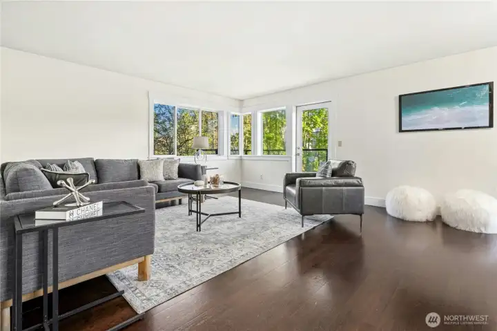 Spacious living room filled with natural light, flowing seamlessly to your private deck.