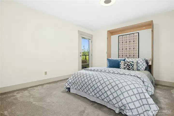 The first bedroom features a Murphy bed, offering flexibility for guests, a home office, or both.