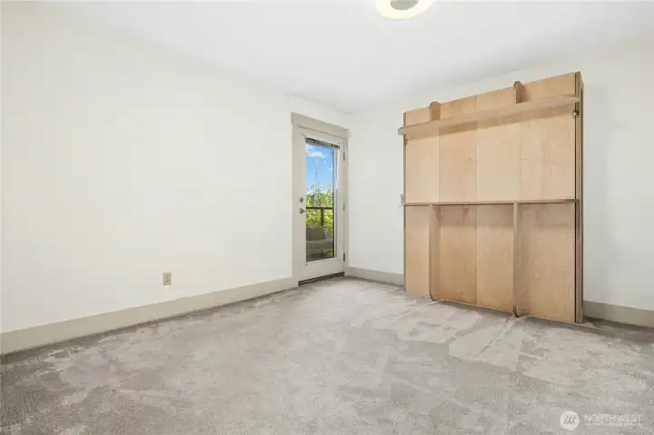 This is the first bedroom again with Murphy bed closed, creating a spacious and versatile space. Don't miss the access to the covered deck.