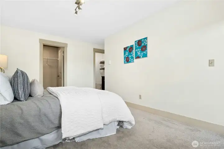 Another look at the primary suite, highlighting the walk-in closet and attached three-quarter bath.