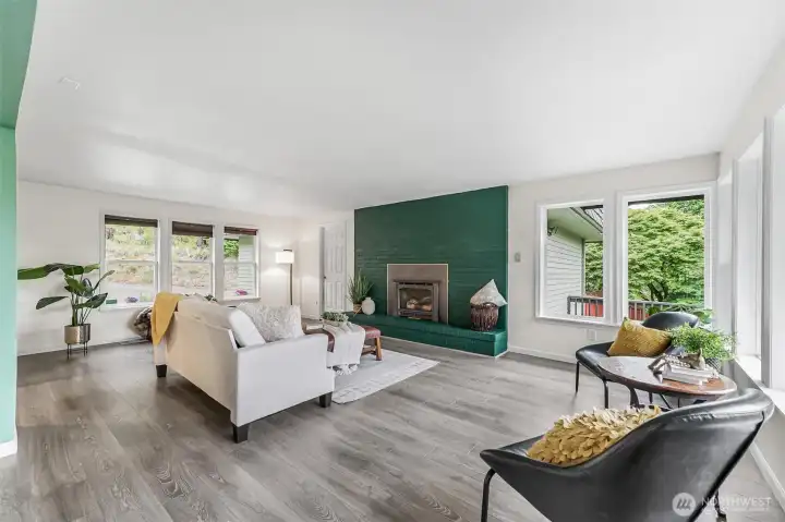 large picture windows and wood burning fireplace