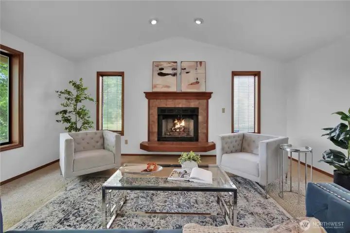 Lots of natural light in living room with gas fire place