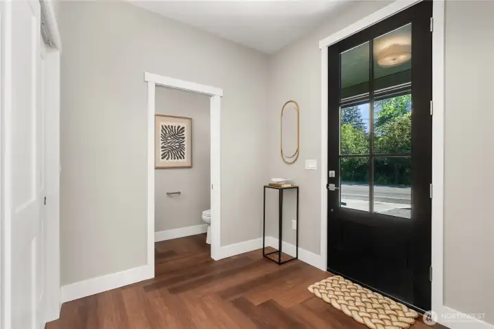 Check the scale of this front door! Half bath/powder room and coat closet are conveniently located at the home's entrance Check the scale of this front door! Half bath/powder room and coat closet are conveniently located at the home's entrance