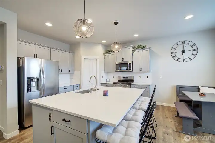 The heart of the home: an open kitchen with expansive island seating and abundant storage.