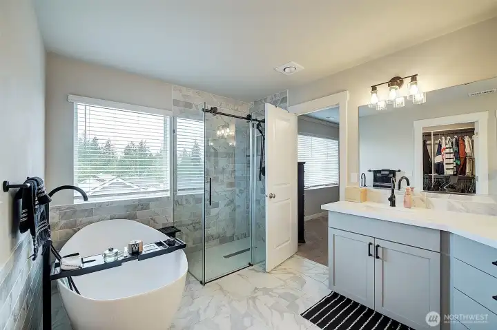 Freestanding soaking tub, oversized tiled shower and thoughtfully selected modern finishes.