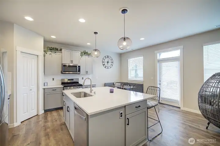 Generous prep space, modern finishes and an island built for everyday connection. Don't miss the causal seating in the corner too!