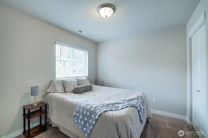 Comfortable secondary bedroom with flexible space for family or guests.