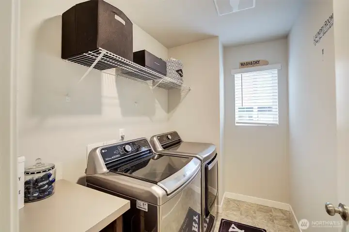 A dedicated laundry room adds storage and everyday convenience.
