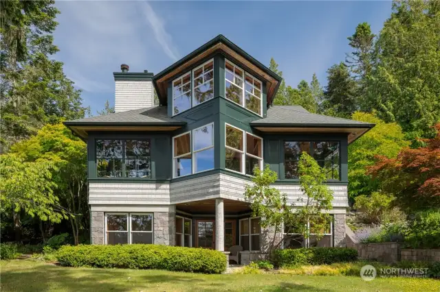 NW style custom home privately sited on 582 feet of waterfront with 13.24 acres.
