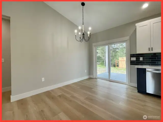 Dining area with sliding door leading to the deck and back yard.