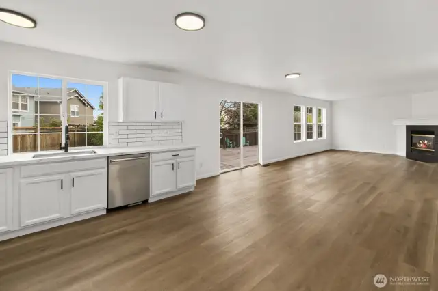The sliding glass door opens to a spacious deck, perfect for entertaining and seamlessly blending indoor and outdoor living.