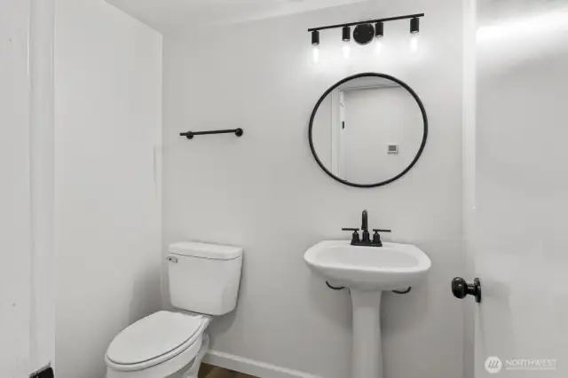 Updated powder room on the main level, with a spacious storage closet nearby (not pictured).
