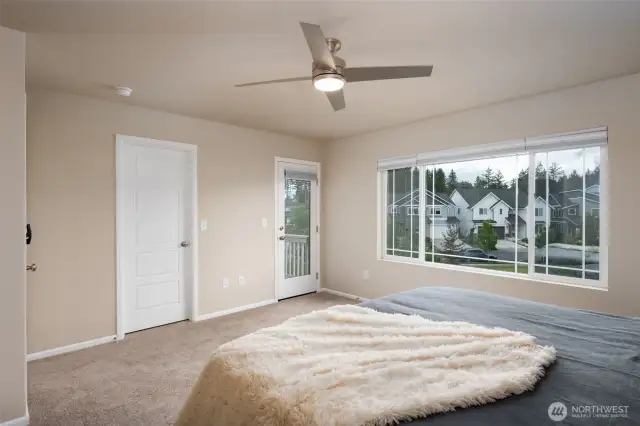Lots of light in primary suite with new carpet and access to private balcony.