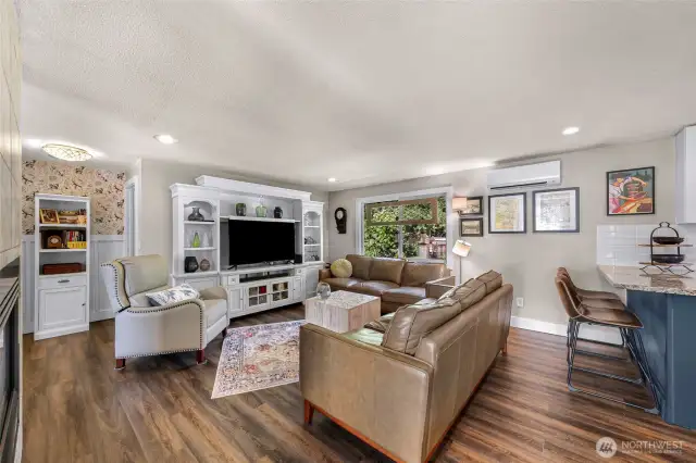 The living area with a bathroom to the left and bedroom to the right