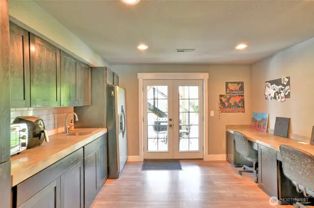 Kitchen in basement looking at door to the back yard