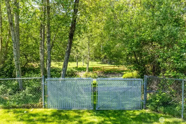 Back gate opens to paved road leading to community dock/beach/cabana/BBQ