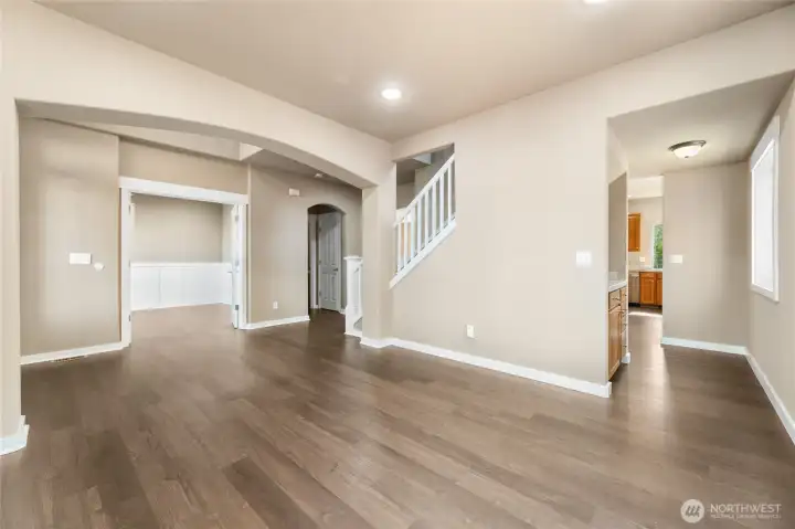 Curved arches, wood wrapped doors & open staircase. Butlers Pantry tucked between the kitchen & flex space.