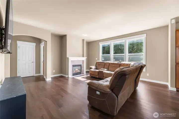 Gas fireplace warms up the livingroom with a wall full of windows.