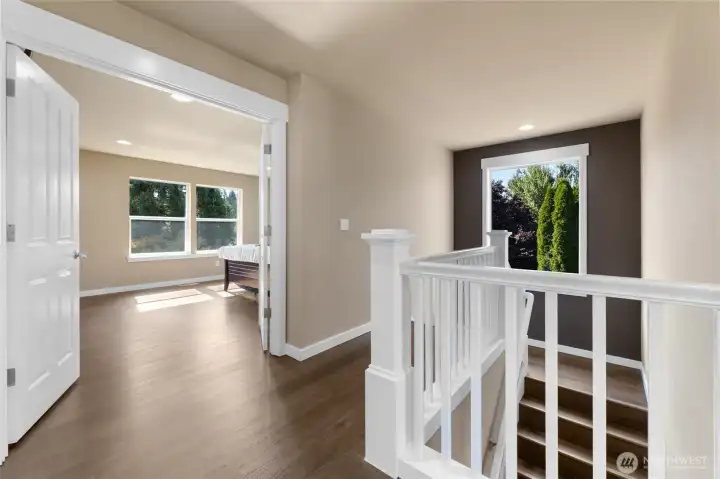 Newer LVP hardwood floors throughout, open railing, french doors leading to primary suite.