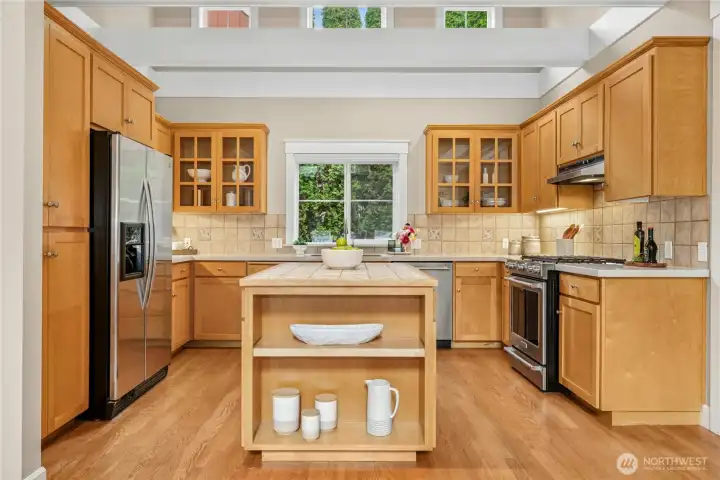With plenty of natural light, workspace, and storage, this thoughtfully designed kitchen offers easy service to the dining room and out to the patio.