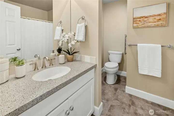 The refreshed shared full bathroom includes a shower/tub combo and is conveniently located near the front entry for guest use.