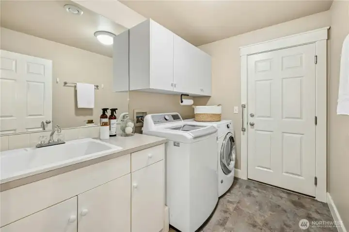 Well-located laundry and utility sink with convenient access to the attached garage.
