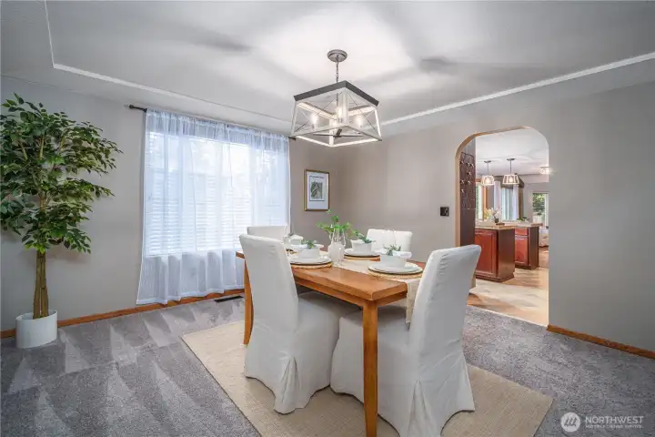 The formal dining room accommodates large furniture and gatherings—note the recessed ceiling here as well.