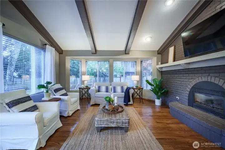 The spacious family room features beamed ceilings and a warm gas fireplace.