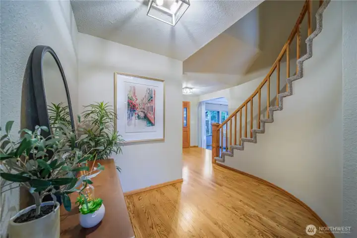 From the family room, head down the hall and up the grand staircase to the four upper-level bedrooms.