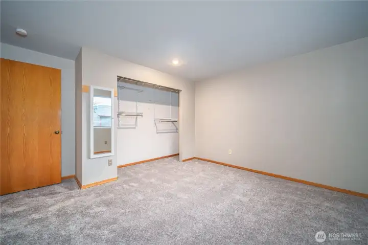 Three additional upper-level bedrooms all feature large closets with organizers—this is the first.