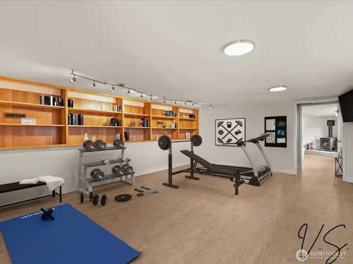 Virtually Staged this Space as Your Weight Room as it is Next to the 3 Car Garage.