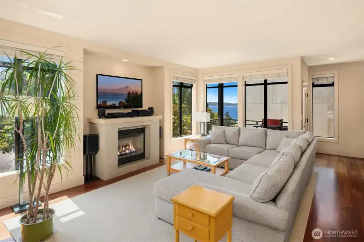 Large living room features the 2nd of 3 gas fireplaces, gorgeous Lake Washington views, a balcony and tons of space!