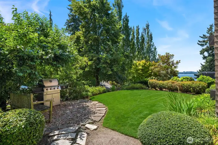 Side garden features community grill and bench, and ample grassy space to sit and watch the water.