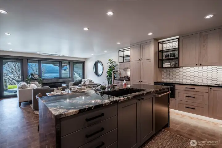 Fully renovated open floor plan with beautiful kitchen counters and luxury appliances. Kitchens opens to the dining area and living room with fireplace and amazing lake views.