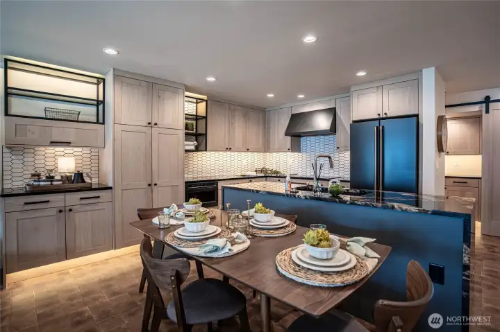 Modern kitchen counters and luxury appliances accented by automatic undercounter and undercabinet lighting. Ample kitchen storage space.