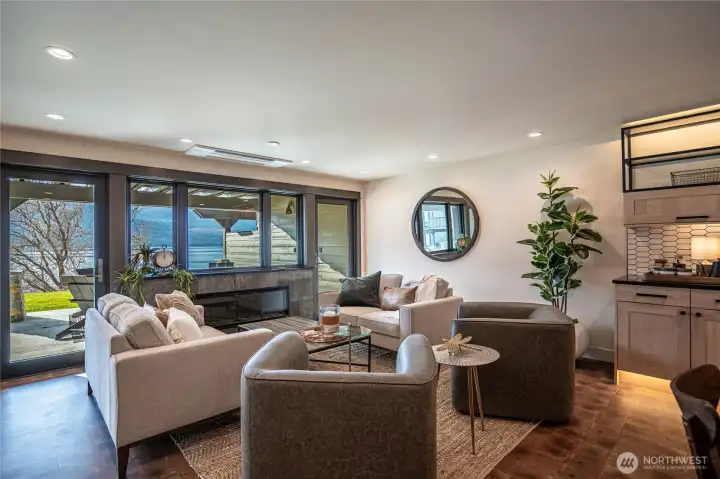 Indoor outdoor living with the fireplace and twin doors opening to the patio.  The living room offers relaxing space all year round.