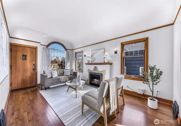 Brimming with character the living room features newly converted gas fireplace and leaded crest window.