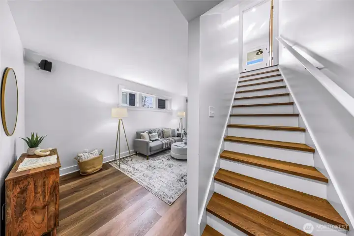 Stairs leading to the nearly 8 foot ceiling basement with new luxury vinyl plank flooring.