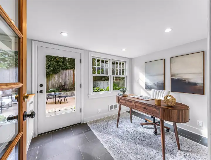 Flex room with wet bar can serve several purposes. Staged as an office and leads to back patio and backyard.