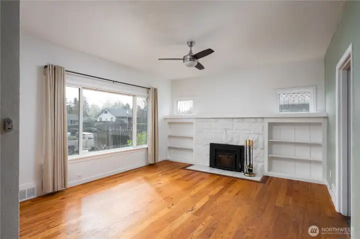 Front door opens up to living room with wood fireplace.