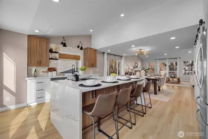 White and walnut cabinetry, quartz counters with warm veining, and black/gold hardware create a timeless, elegant look