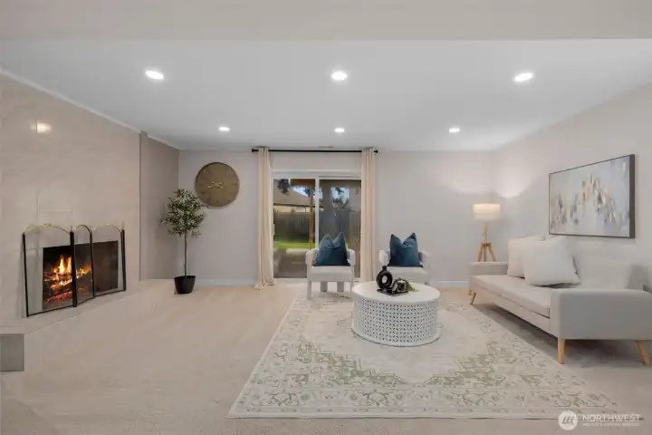 Expansive lower-level family room centered around a charming wood-burning fireplace, creating a warm and inviting retreat