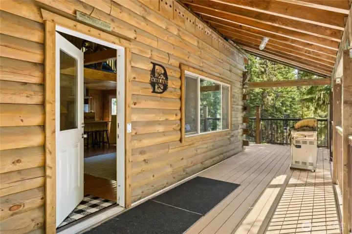 View of front door on main floor. Surrounded by covered deck.
