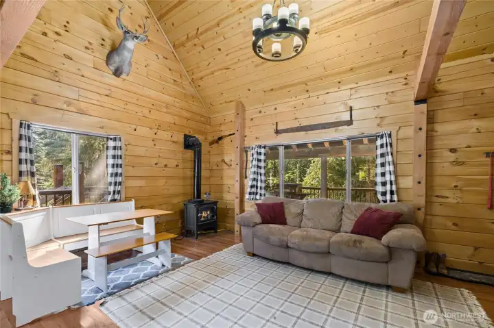 View of living room and dining room area surrounded by beautiful wood accents.