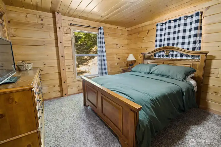 One of 2 bedrooms on the main floor. Look at the beautiful bedroom furniture included!