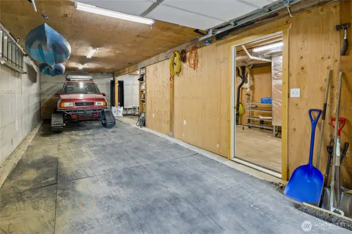 Inside the garage. You can easily park vehicles and or toys. Next to it is the drying room where you can peel out of your wet clothes in the winter and have them perfectly dried in the morning and ready to have another day of adventure in the snow.